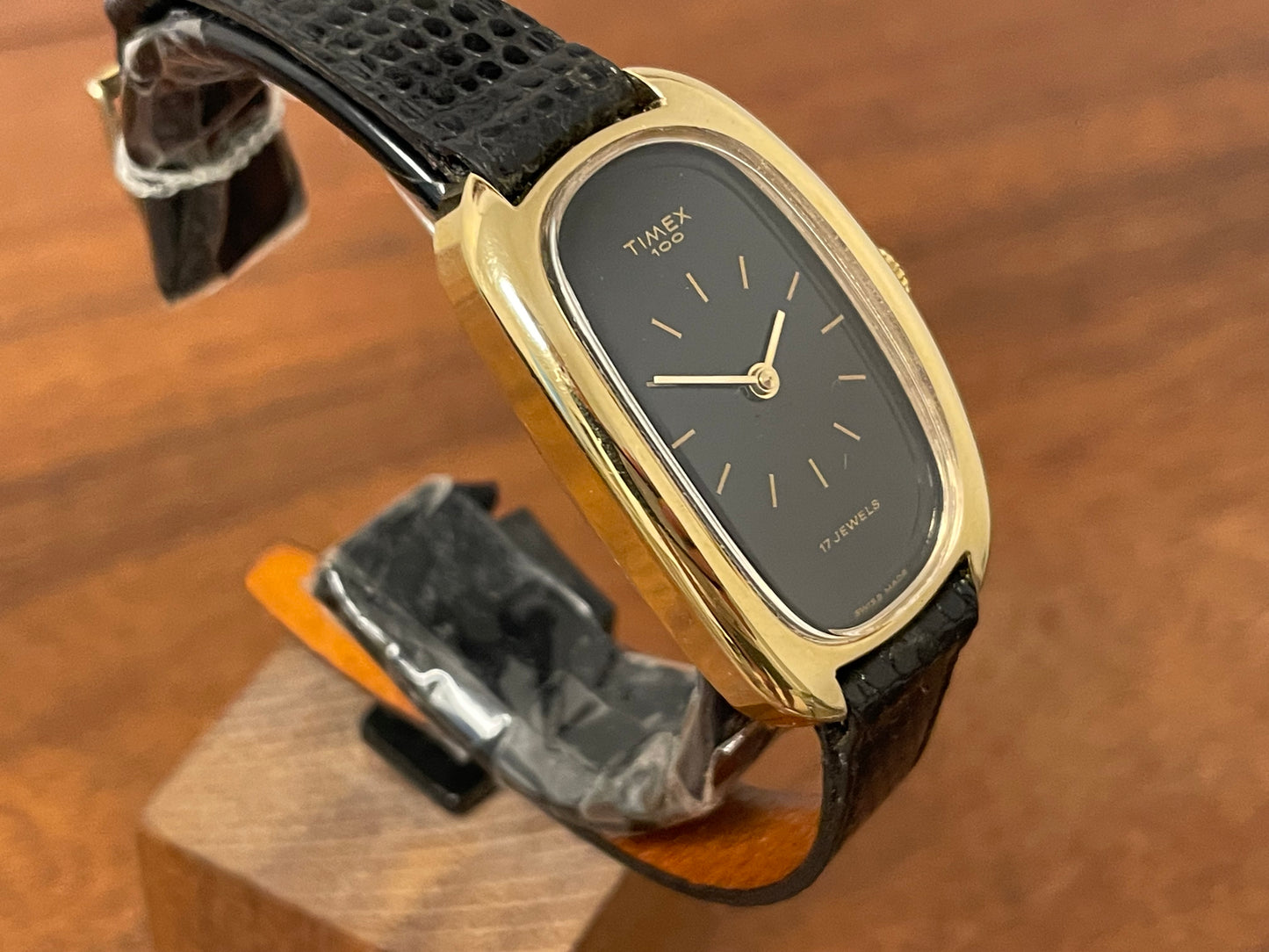 (1979) Timex 100 manual wind dress watch - Swiss made - tonneau case - black dial w/ gold markers
