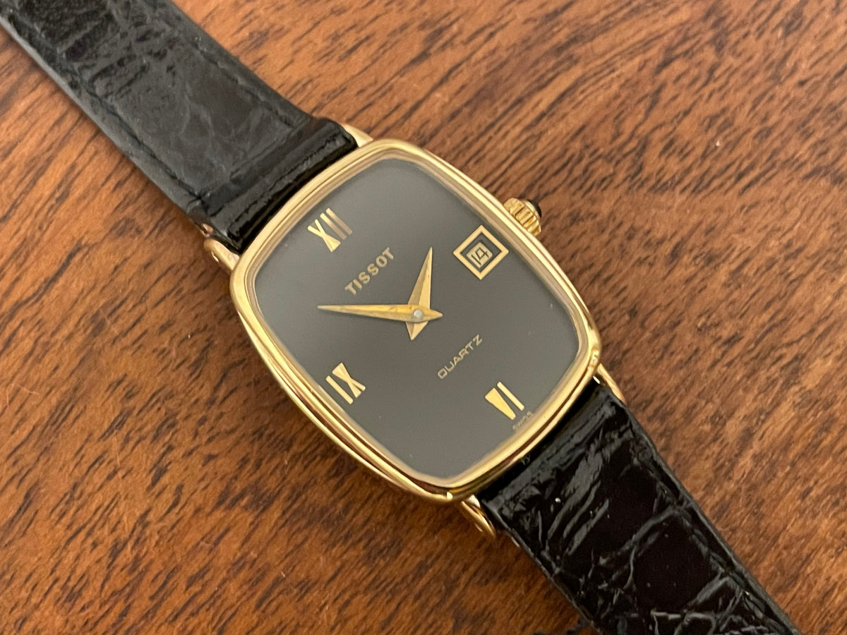 (1980s) Tissot 642.33500/5 Stylist "Ellipse" dress watch - gold case - black dial w/ Roman numerals - small size (NOS)
