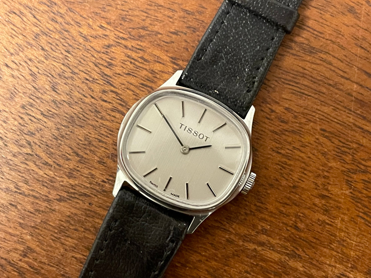 (1970s) Tissot 052-15007 Stylist dress watch - silver cushion case - silver brushed dial w/ silver stick markers - small size (NOS)