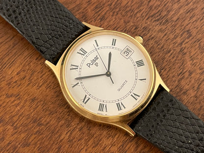 (1990) Pulsar Y552-8009 dress watch - gold colored case - white dial w/ black Roman numerals (NOS)