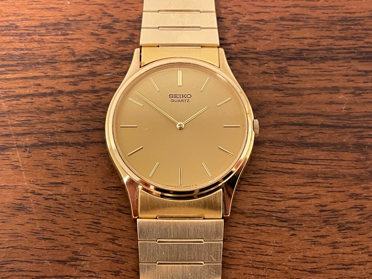 (1983) Seiko 8420-0140 dress watch - gold case - gold sunburst dial w/ gold stick markers (NOS)