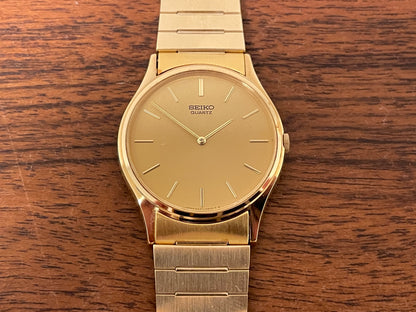 (1983) Seiko 8420-0140 dress watch - gold case - gold sunburst dial w/ gold stick markers (NOS)