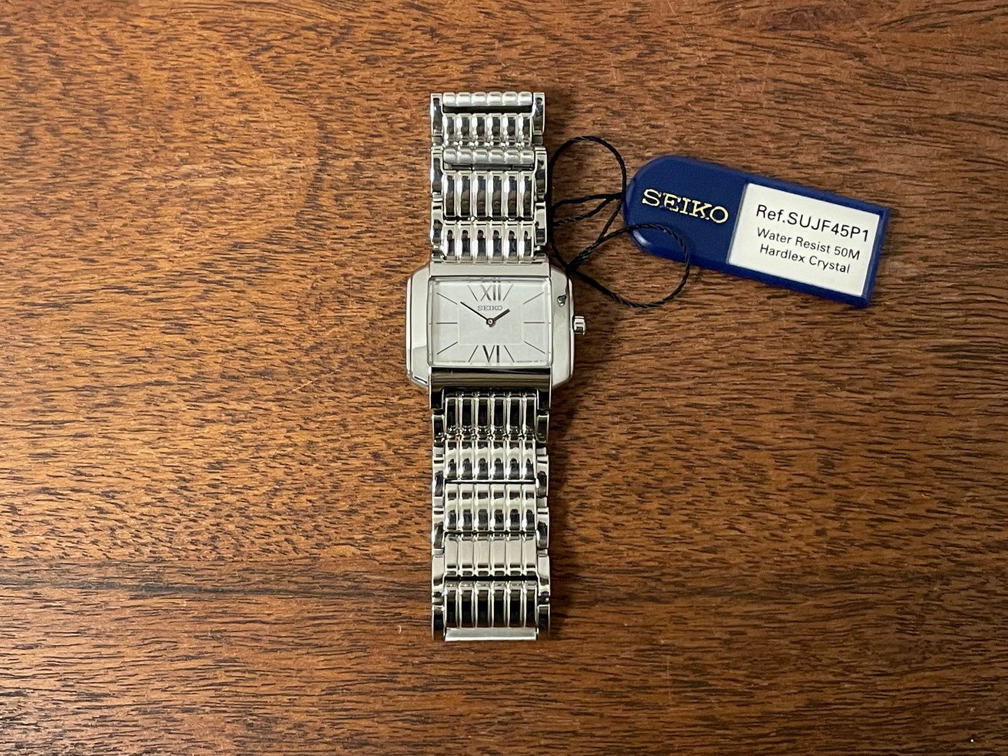 (1998) Seiko 1N00-0PT0 - rectangular case - silver dial w/ silver Roman numerals & markers - small size (NOS)