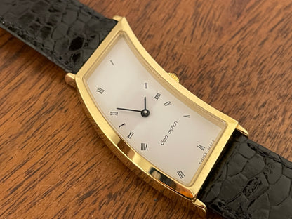 (1988) Cleto Munari "Parentesi" by Hans Hollein - asymmetrical 18K gold electroplated case - white dial w/ Roman numerals  (NOS + full set)