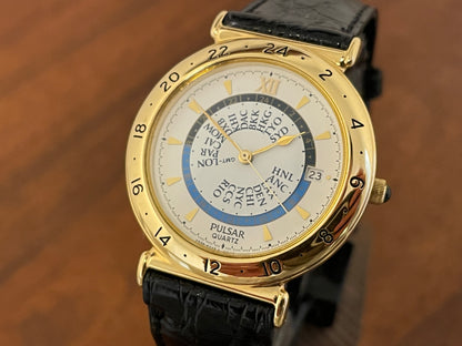 (1999) Pulsar V339-6000 world Timer - gold case - rotating white dial w/ gold markers (NOS)