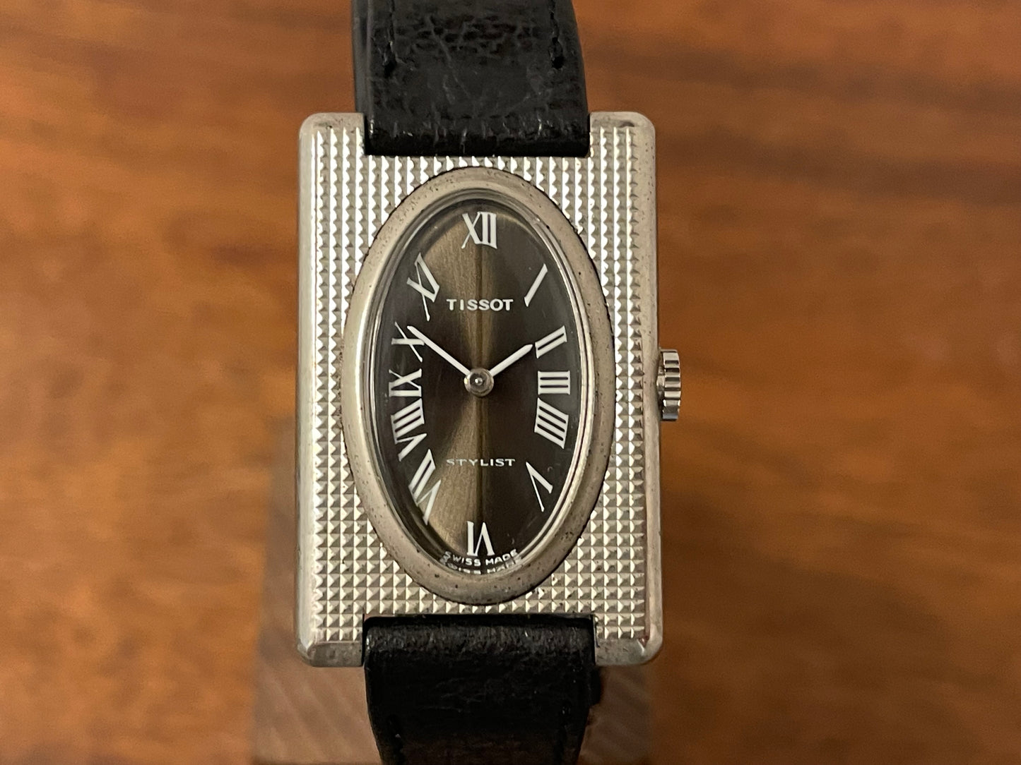 (1970s) Tissot Stylist "Tank" - decorated case - black sunburst dial w/ white Roman numerals - small size (NOS)