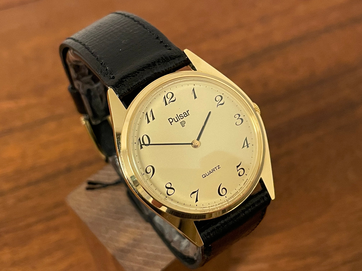 (1991) Pulsar Y480-0460 dress watch - gold colored case - matt champagne dial w/ black Arabic numerals - (NOS)