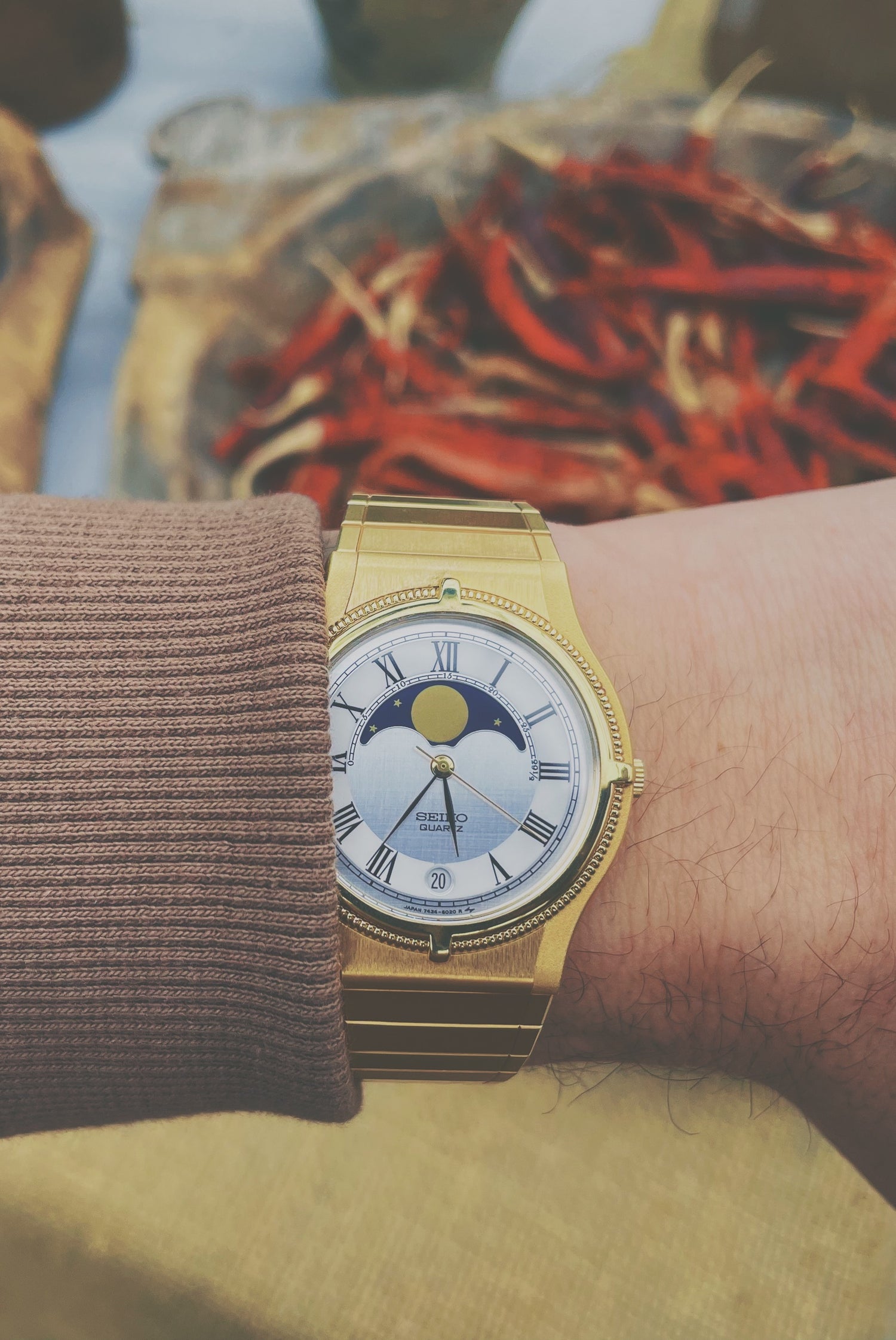 Gold colored Seiko with moon phase complication on the wrist