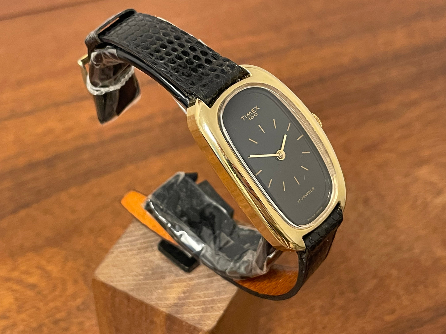 (1979) Timex 100 manual wind dress watch - Swiss made - tonneau case - black dial w/ gold markers