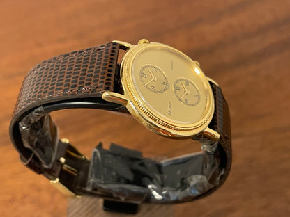 (1985) Seiko 1E20-0160 dual time dress watch - round case - gold textured dial w/ 2 subdials