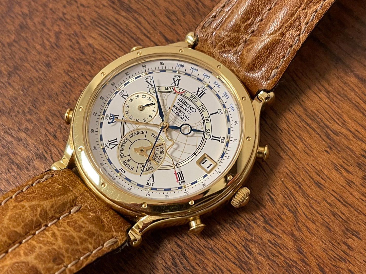 (1994) Seiko 6m13-0010 Age of Discovery (AOD) Perpetual Calendar - gold colored case - white dial w/ black Roman numerals