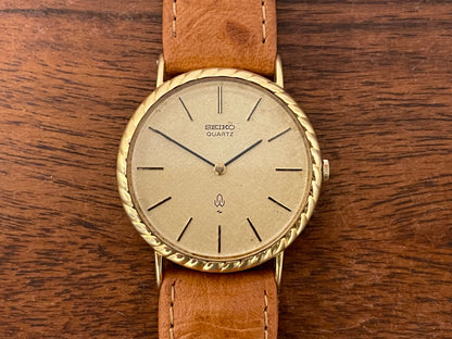 (1977) Seiko 43-0150 14K solid gold dress watch - rope bezel -  gold textured dial w/ gold markers