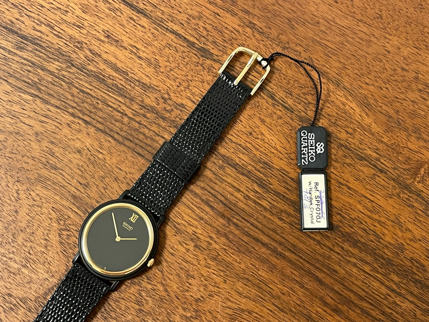 (1993) Seiko 6530-5120 dress watch- oval black case w/ gold bezel en hands (NOS)