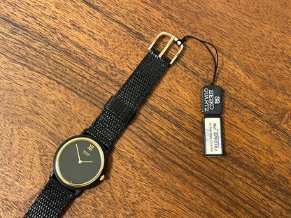 (1993) Seiko 6530-5120 dress watch- oval black case w/ gold bezel en hands (NOS)