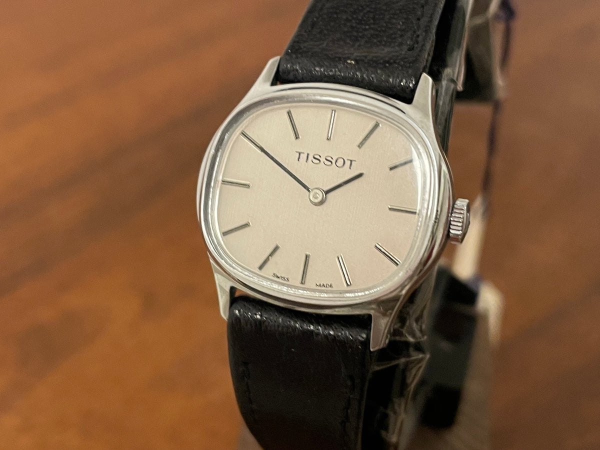 (1970s) Tissot 052-15007 Stylist dress watch - silver cushion case - silver brushed dial w/ silver stick markers - small size (NOS)