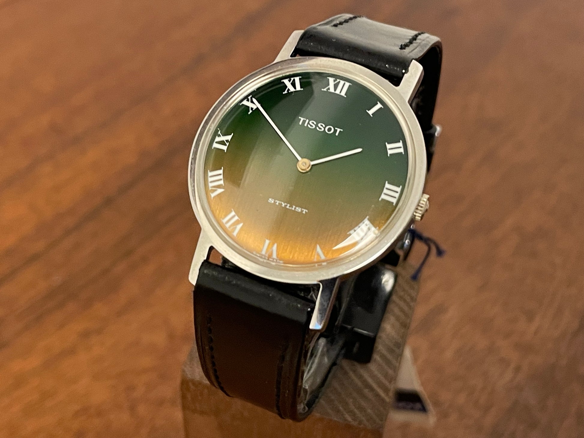 Front side (1970s) Tissot Stylist dress watch - silver case - brushed green/orange gradient dial w/ white Roman numerals (NOS)