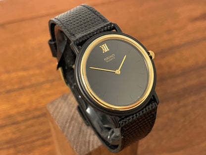 (1993) Seiko 6530-5120 dress watch- oval black case w/ gold bezel en hands (NOS)