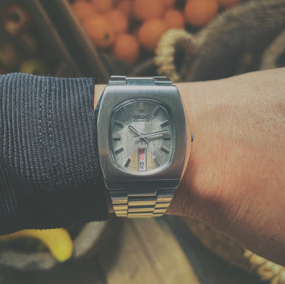 Vintage Seiko Quartz 3003 on wrist with fruits in the background