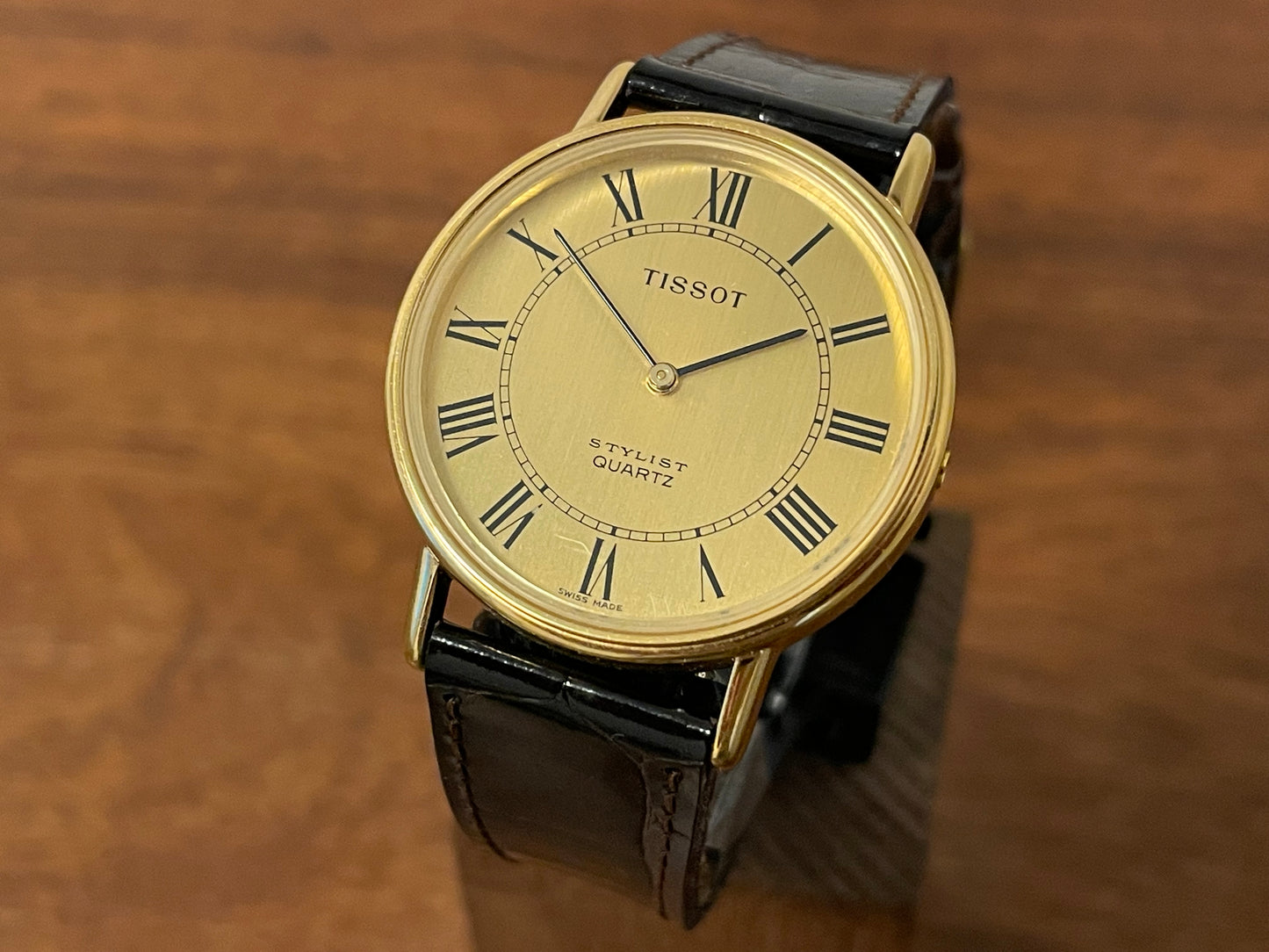 Front side (1970s) Tissot Stylist dress watch - gold case - brushed gold dial w/ black Roman numerals (NOS)