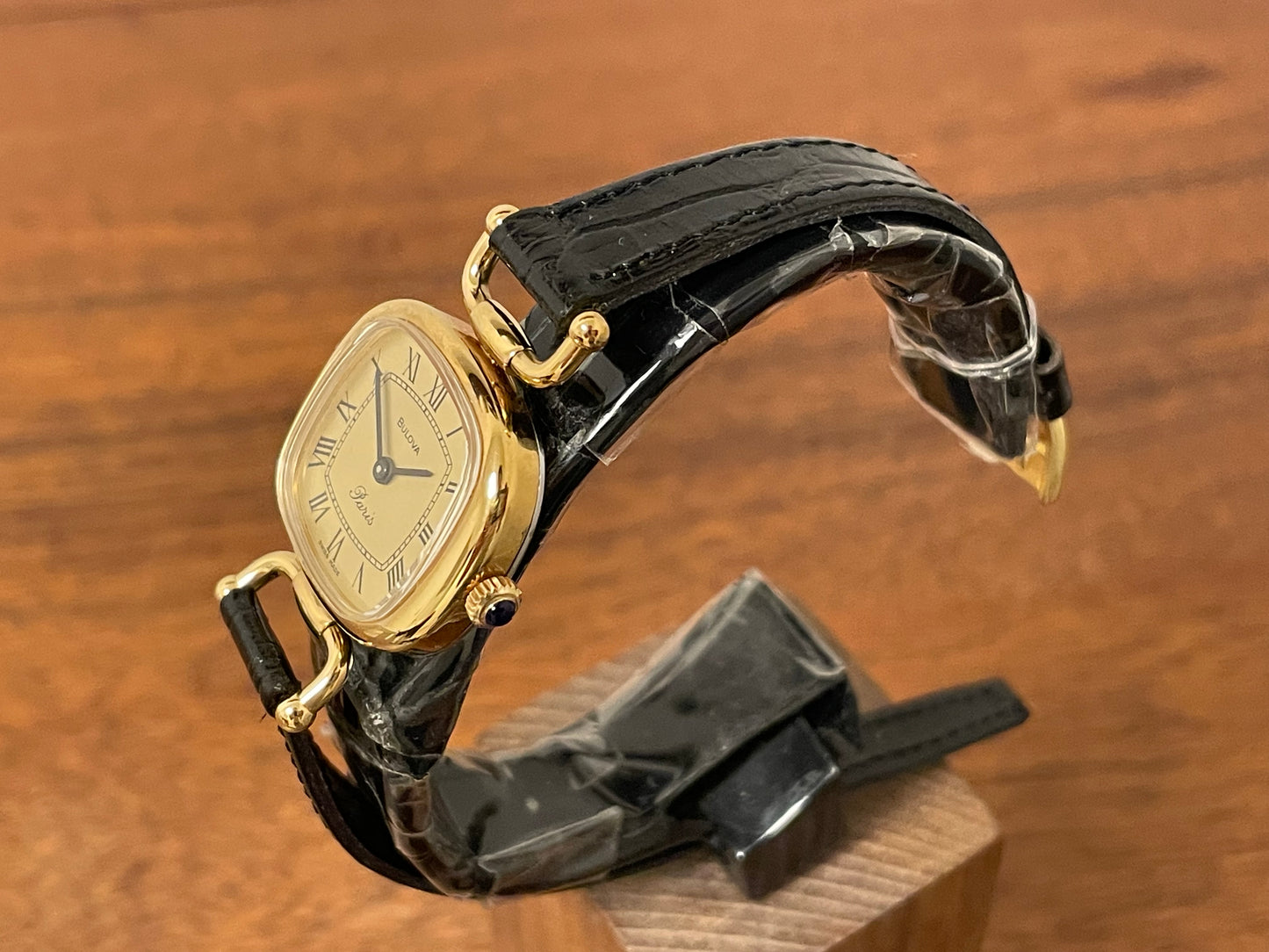 (1980s/1990s) Bulova Paris dress watch - cushion case - gold dial w/ black Roman numerals - small size (NOS)