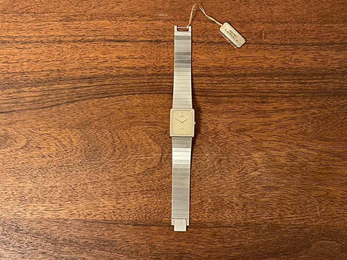 (1983) Seiko 6730-565H Lassale ultra thin - stainless steel bracelet - brushed gold dial w/ black stick markers (NOS)