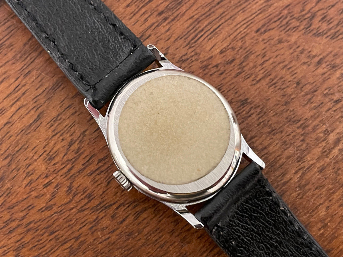(1970s) Tissot 052-10991 Stylist dress watch - silver oval case - silverdust dial w/ silver stick markers - small size (NOS)