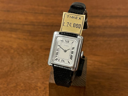 Front side (1970s) Timex "Tank" dress watch - silver case - white dial w/ Roman numerals - small size (NOS)