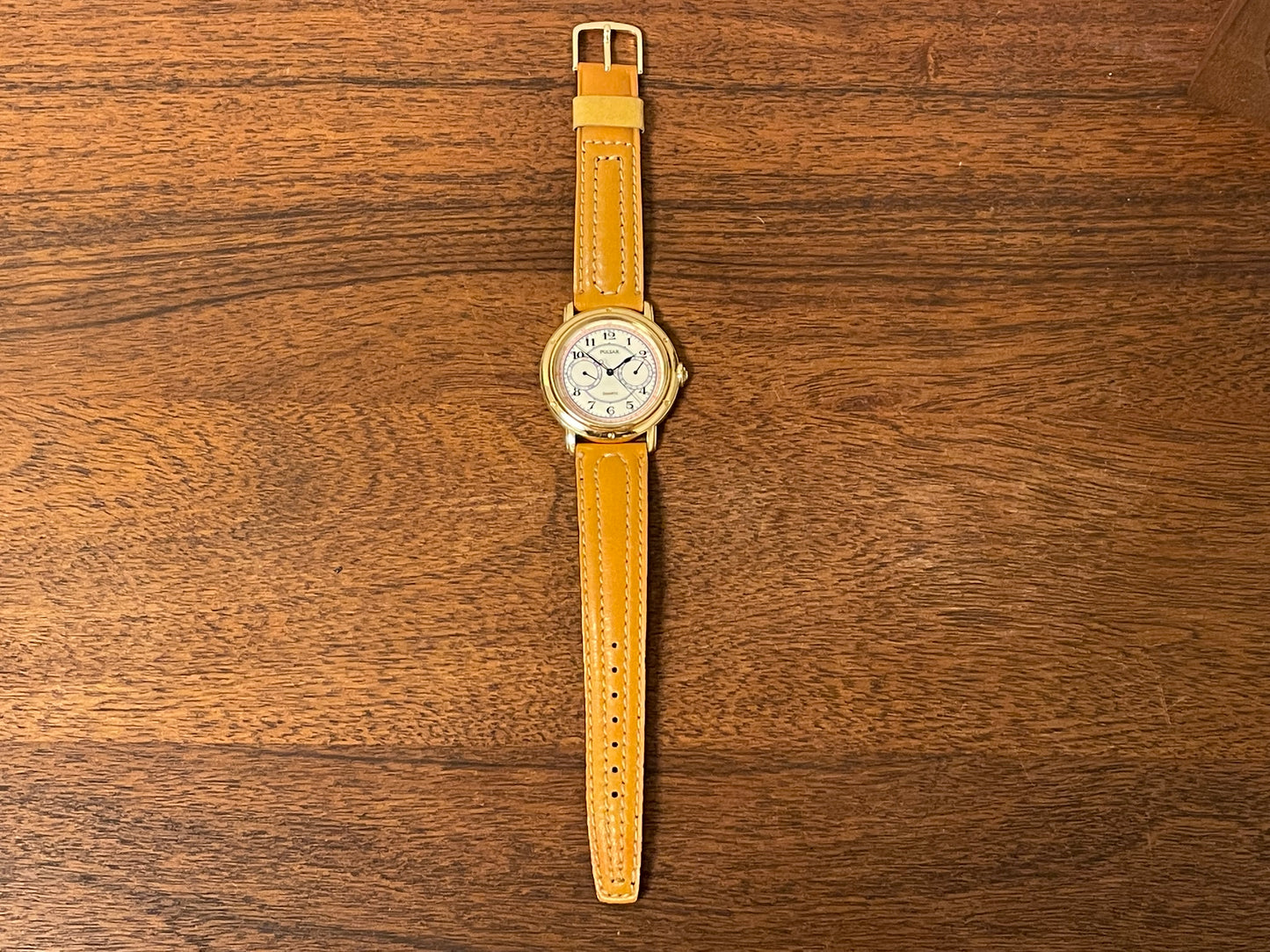 (1988) Pulsar V336-7040 dress watch - gold colored case - creme dial w/ Arabic numerals