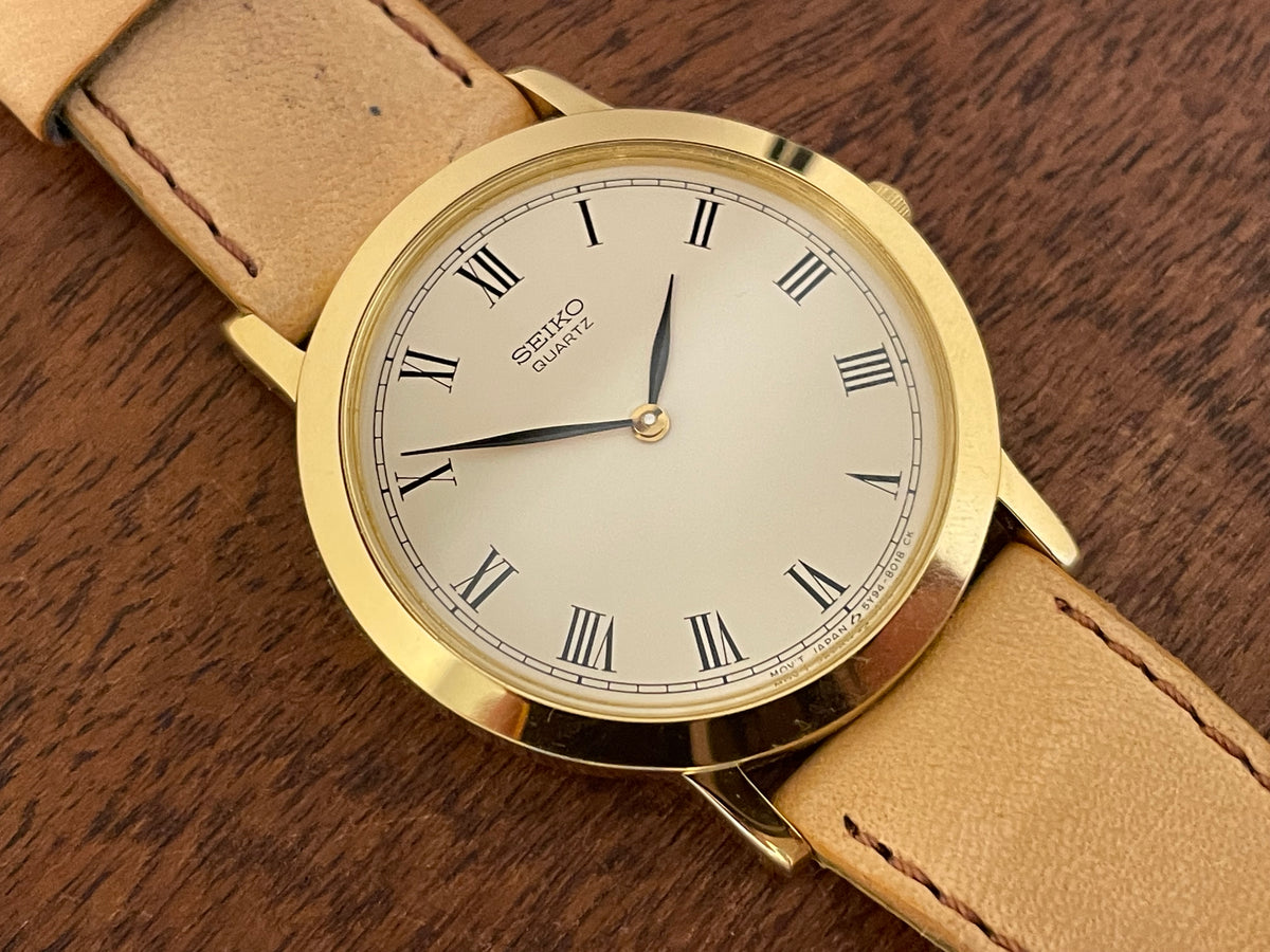 (1989) Seiko 5Y94-8000 dress watch - gold case - cream dial w/ black Roman numerals (NOS)