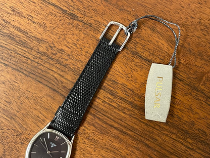 (1982) Pulsar Y112-5099 "Ellipse" dress watch - silver case - black dial w/ silver stick markers (NOS)