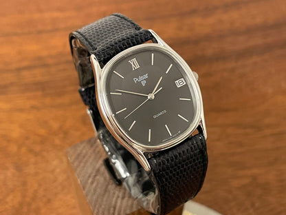 (1982) Pulsar Y112-5099 "Ellipse" dress watch - silver case - black dial w/ silver stick markers (NOS)