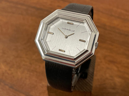 Front side (1974) Caravelle dress watch - octagon case - brushed silver dial w/ stick markers (mint)
