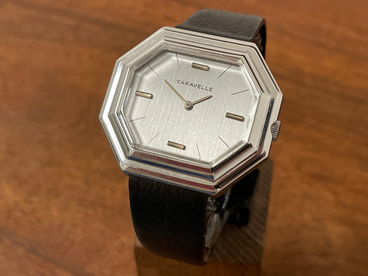 Front side (1974) Caravelle dress watch - octagon case - brushed silver dial w/ stick markers (mint)
