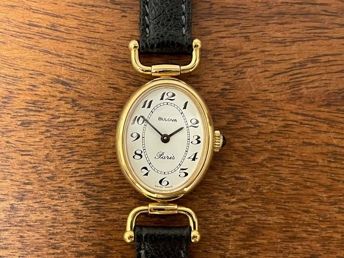 (1980s/1990s) Bulova Paris dress watch - oval case - cream dial w/ black Arabic numerals - small size (NOS)