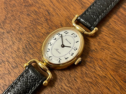 (1980s/1990s) Bulova Paris dress watch - oval case - cream dial w/ black Arabic numerals - small size (NOS)