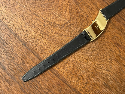 (1988) Cleto Munari "Parentesi" by Hans Hollein - asymmetrical 18K gold electroplated case - white dial w/ Roman numerals  (NOS + full set)