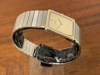 (1983) Seiko 6730-565H Lassale ultra thin - stainless steel bracelet - brushed gold dial w/ black stick markers (NOS)