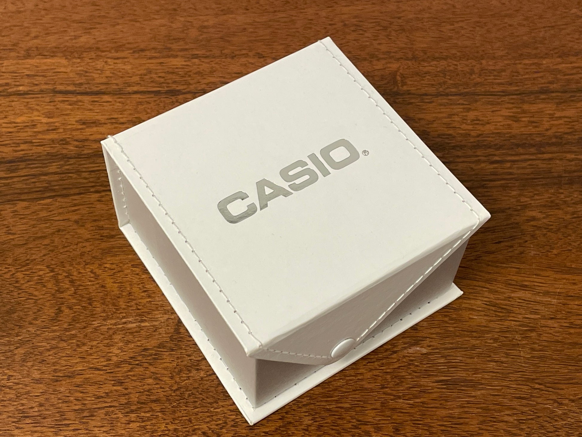 Casio watch box - white w/ fold-over lid and snap button closure