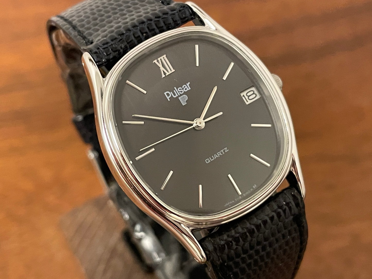 (1982) Pulsar Y112-5099 "Ellipse" dress watch - silver case - black dial w/ silver stick markers (NOS)