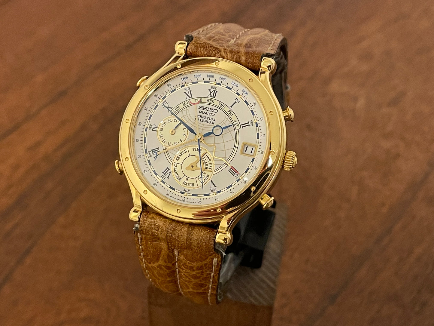 Front view (1994) Seiko 6m13-0010 Age of Discovery (AOD) Perpetual Calendar - gold colored case - white dial w/ black Roman numerals