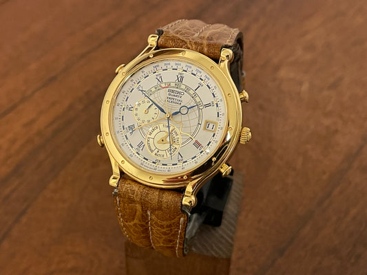 Front view (1994) Seiko 6m13-0010 Age of Discovery (AOD) Perpetual Calendar - gold colored case - white dial w/ black Roman numerals