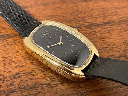 (1979) Timex 100 manual wind dress watch - Swiss made - tonneau case - black dial w/ gold markers