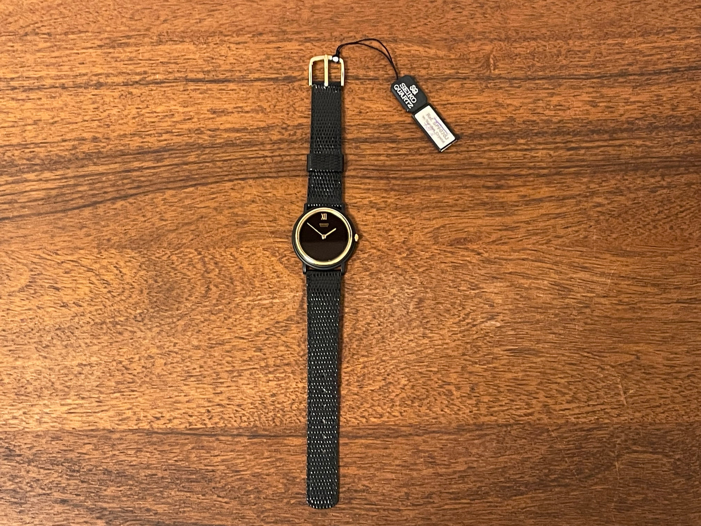 (1993) Seiko 6530-5120 dress watch- oval black case w/ gold bezel en hands (NOS)