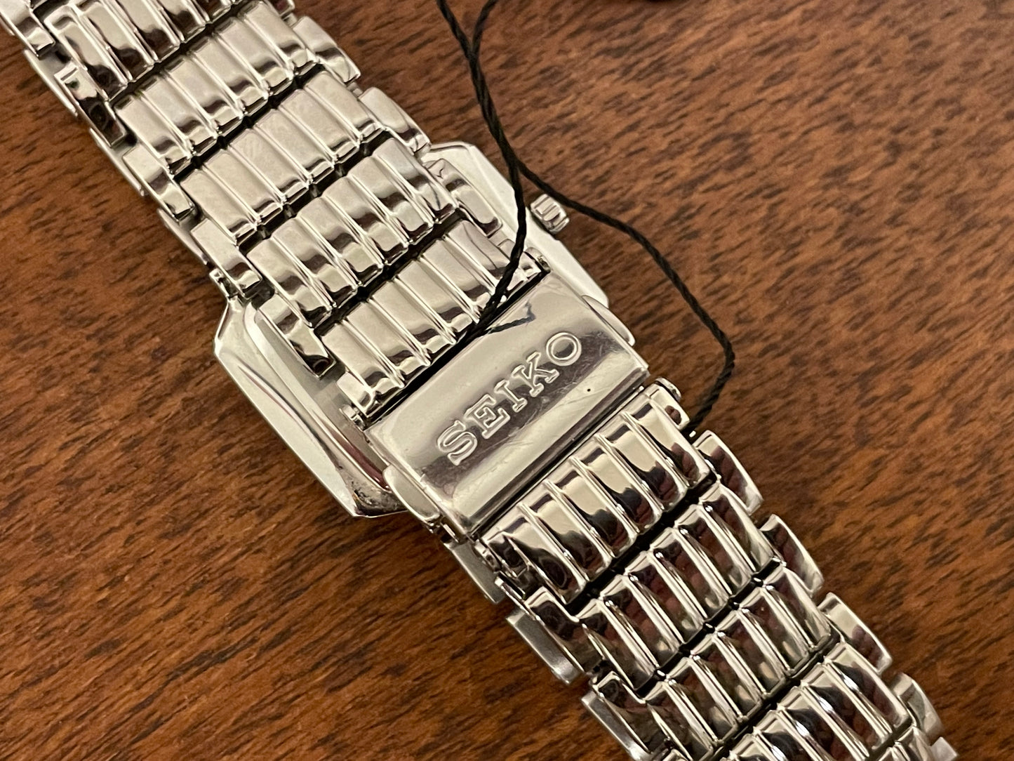 (1998) Seiko 1N00-0PT0 - rectangular case - silver dial w/ silver Roman numerals & markers - small size (NOS)