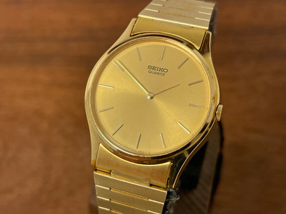 (1983) Seiko 8420-0140 dress watch - gold case - gold sunburst dial w/ gold stick markers (NOS)