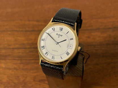 Front side (1990) Pulsar Y552-8009 dress watch - gold colored case - white dial w/ black Roman numerals (NOS)