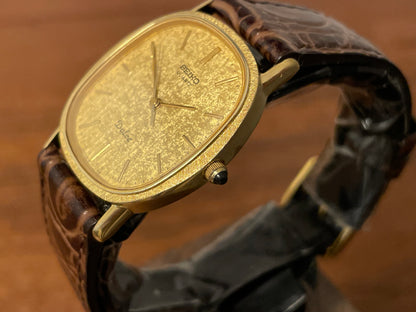 (1981) Seiko 6030-5410 Dolce "Ellipse" - gold plated case w/ etched bezel - gold textured dial w/ gold markers