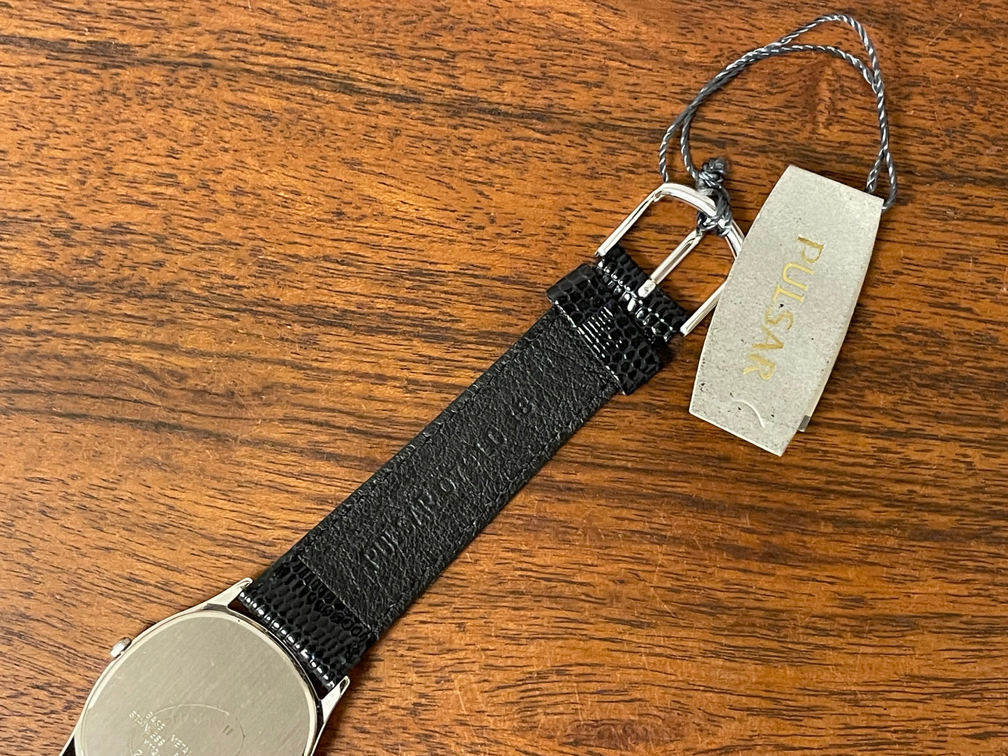(1982) Pulsar Y112-5099 "Ellipse" dress watch - silver case - black dial w/ silver stick markers (NOS)
