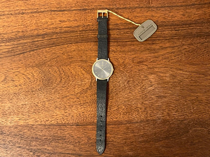 (1980s) Universal Genève 6-566 dress watch - silver case w/ gold beaded bezel - grey sunburst dial (NOS)