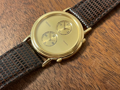 (1985) Seiko 1E20-0160 dual time dress watch - round case - gold textured dial w/ 2 subdials